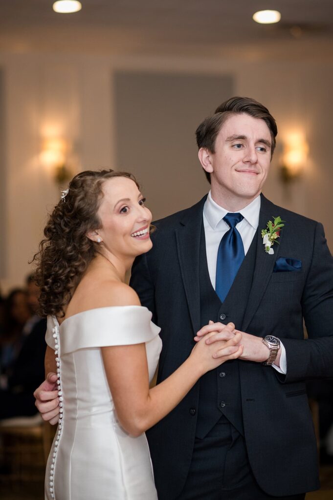 bride and groom smile during their first dance