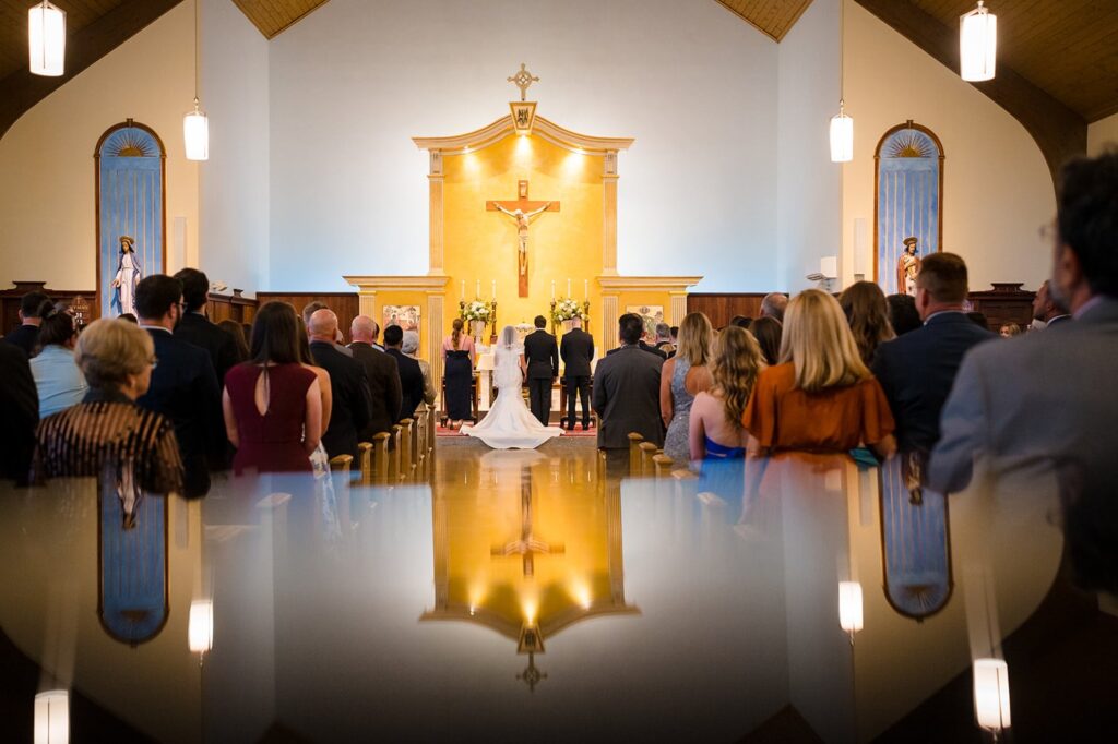 the altar and front of a church are reflected in this mirror image in a church in stonington ct