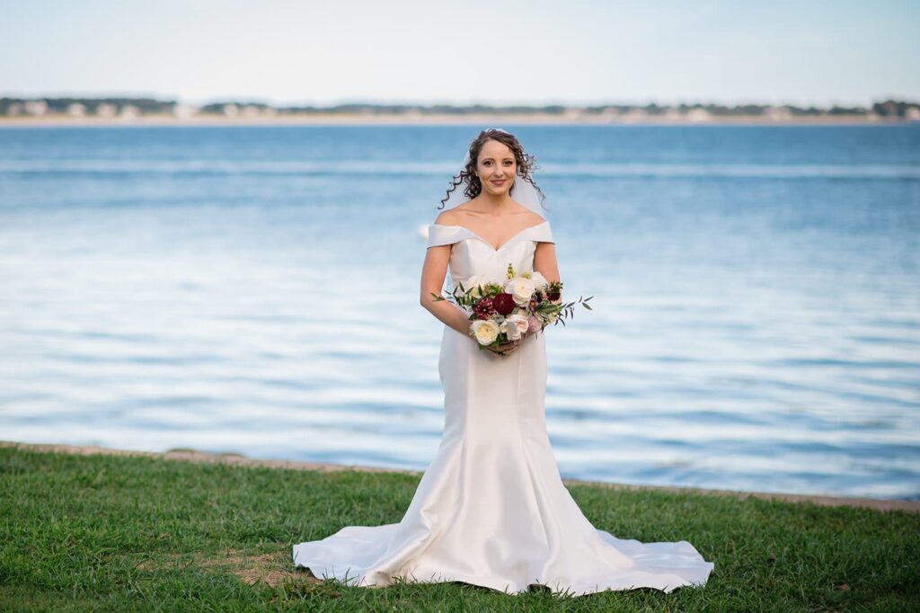bride holds bouquet and smiles at the stonington lighthouse museum